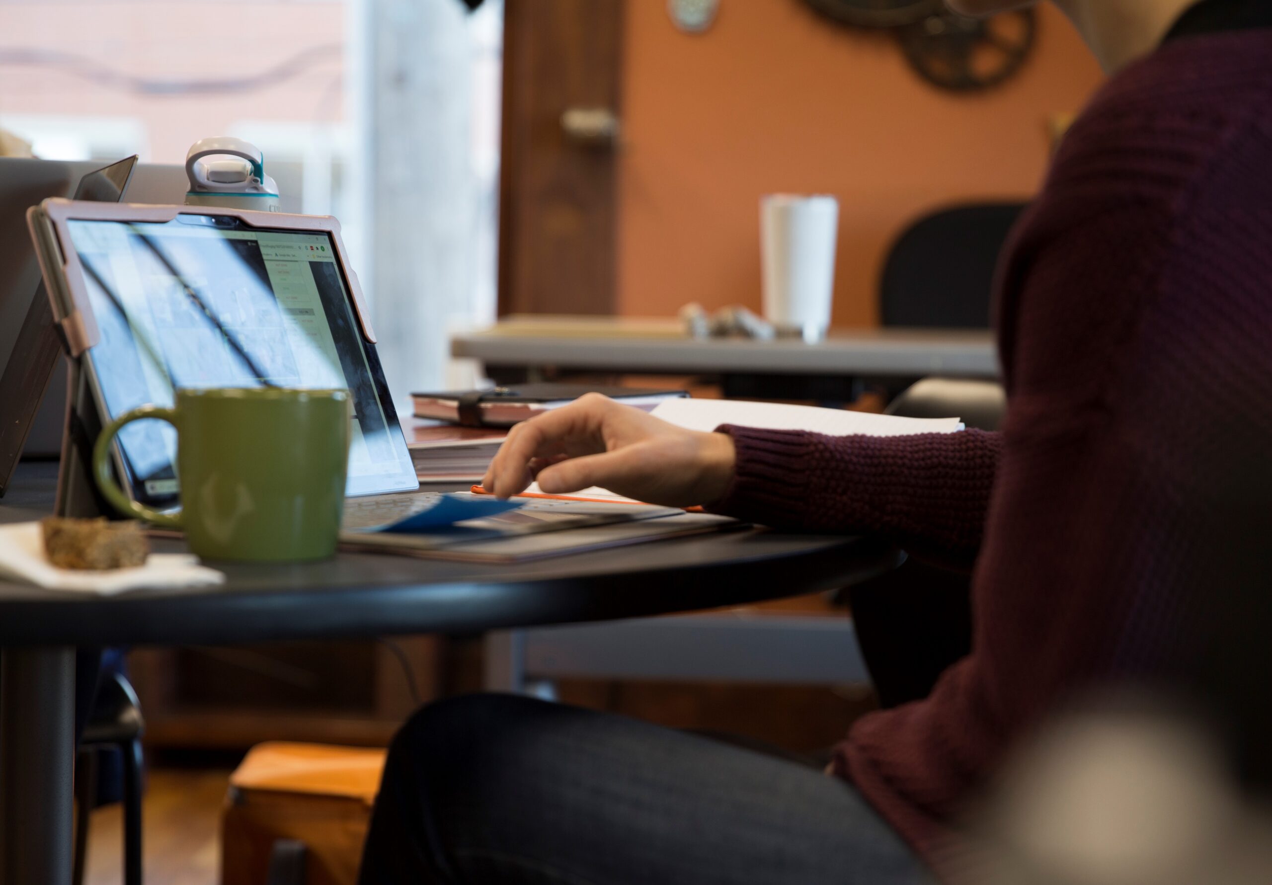 person working in an office at a laptop