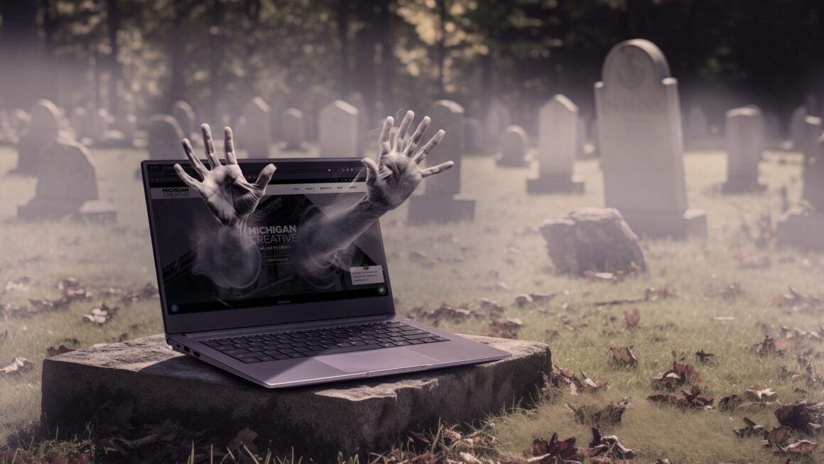 Ghostly hands coming from a Haunted Website and Computer in Graveyard